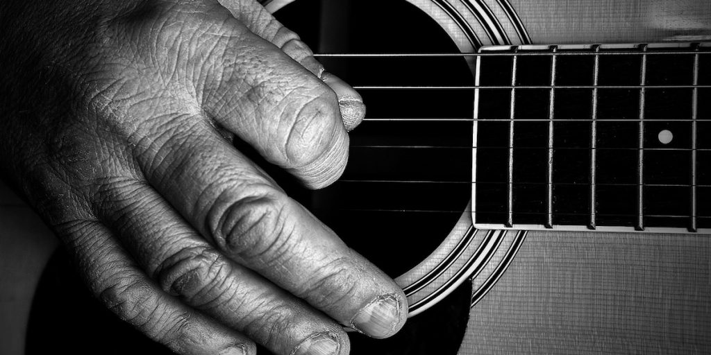 Strumming a guitar