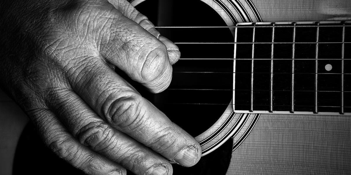 Strumming a guitar