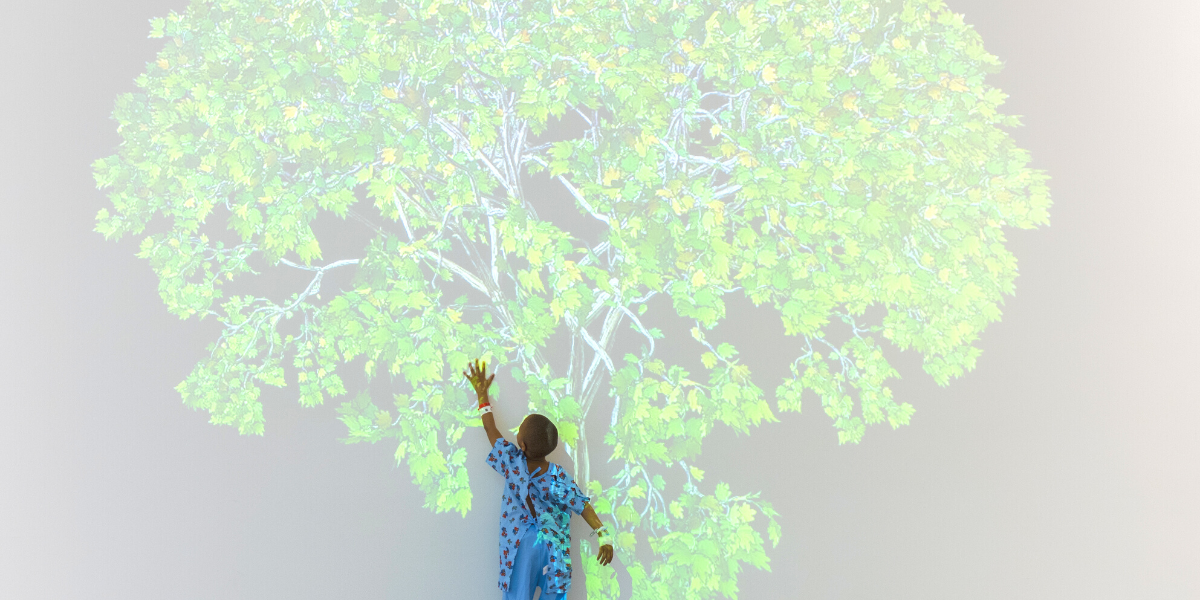 Child patient reaching for tree art