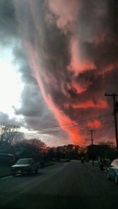 An illusion of a face appearing the clouds at sunset