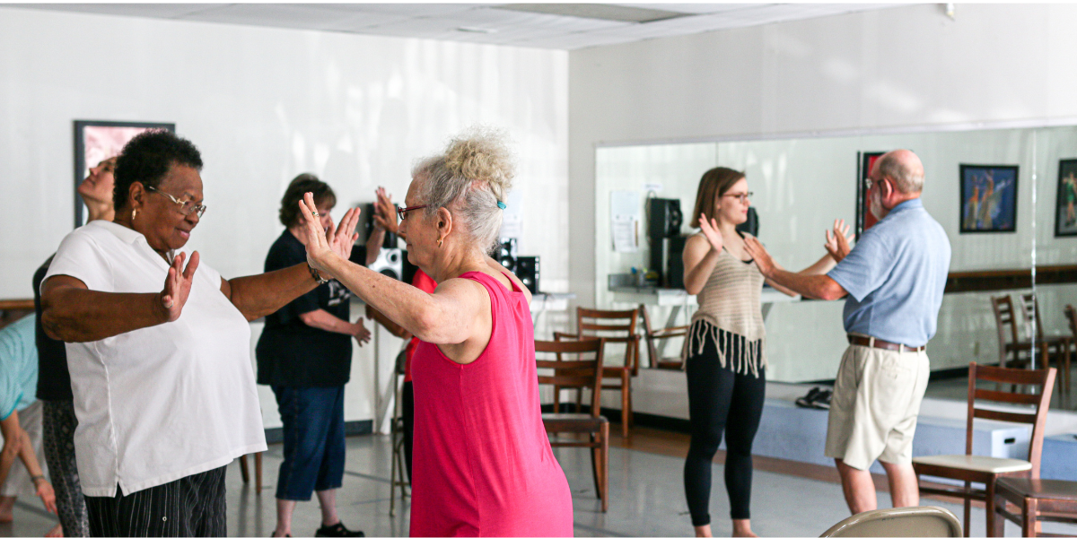 A diverse group of participants take part in an Improvment dance experience